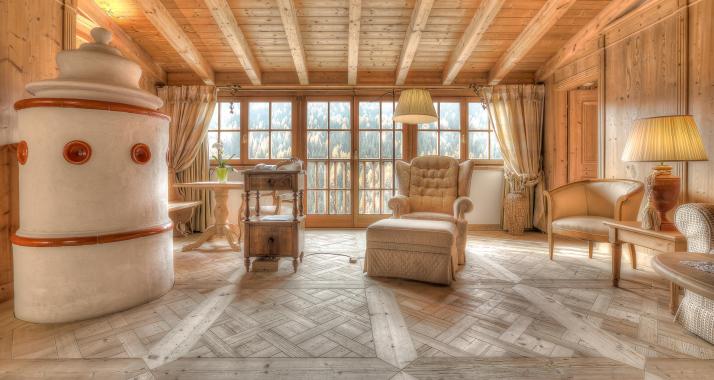 Living room with antique furniture, woooden floor and majolica stove